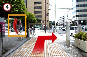 直進すると、左手に赤いモニュメントが見えてきます。赤いモニュメントが見える交差点で右折します。